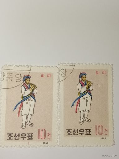 Корея 1963 год   На марках изображен человек, играющий на корейском духовом инструменте.
